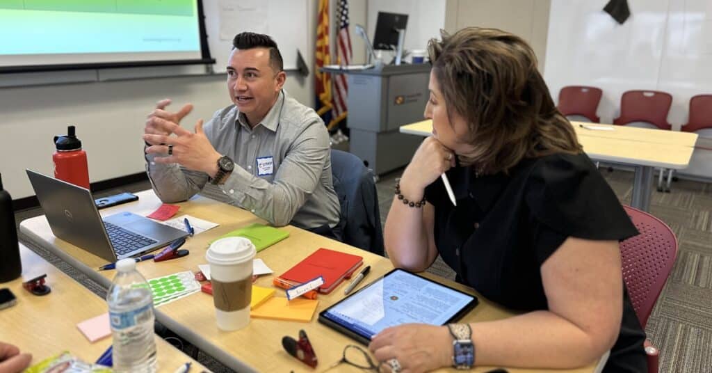 Lead for Learners steering committee members Hector Estrada and Jeni Gotto in discussion with someone off-camera