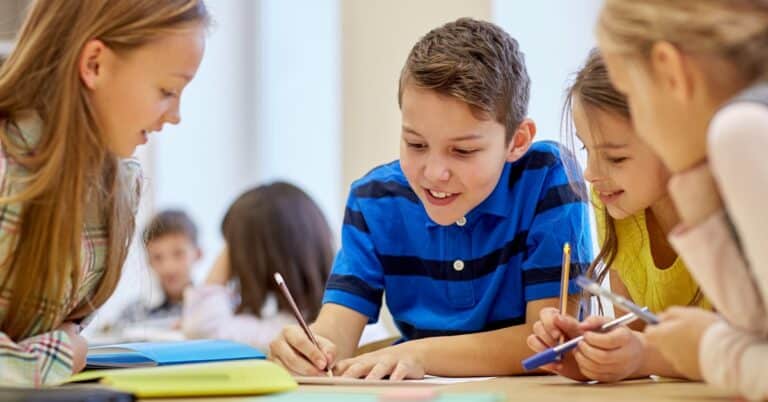 group of students talking and writing at school